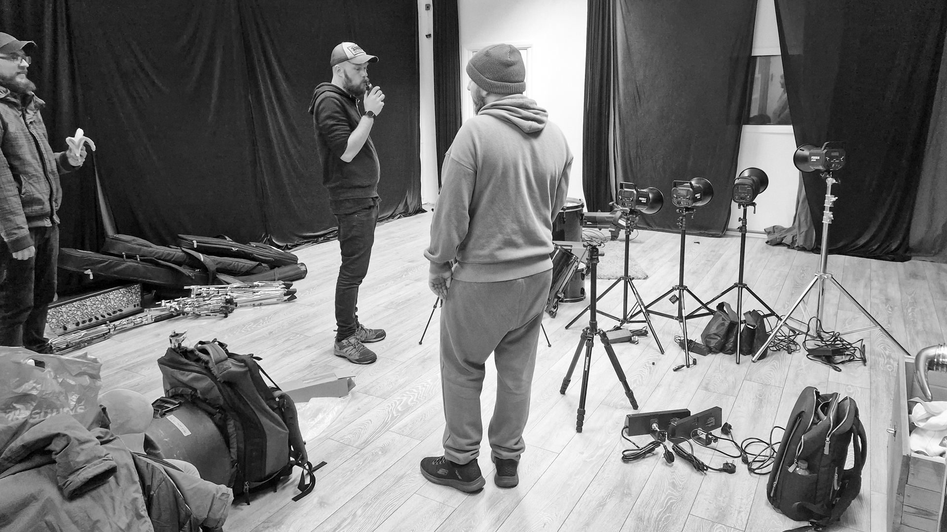 People on a film or photography set, with cameras and equipment, preparing for a shoot.