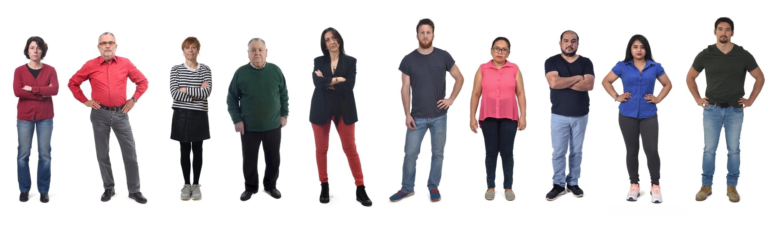 Group of eleven diverse people standing with arms crossed or on hips, wearing casual clothing, posing against a white background.