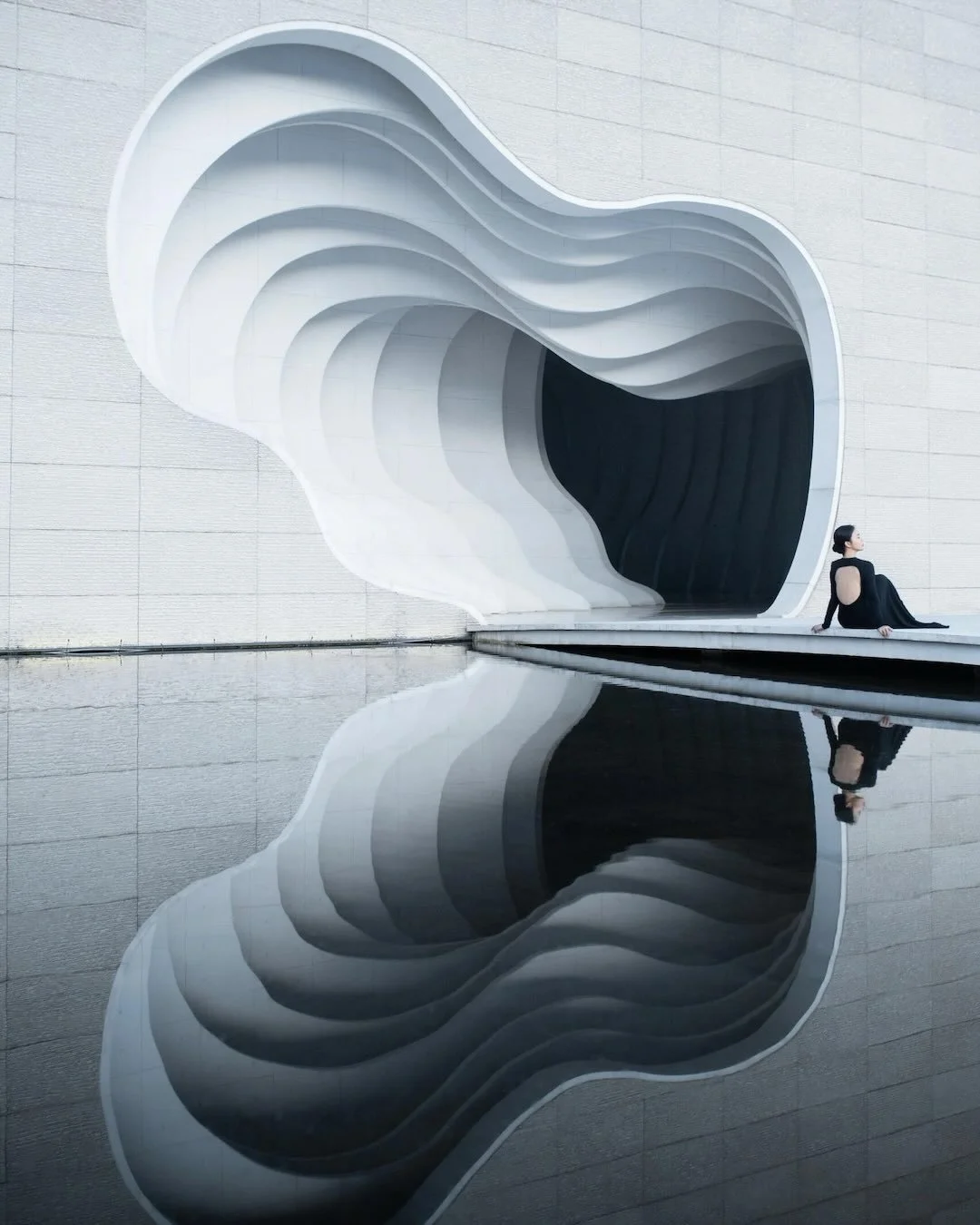 Cast-in-situ concrete forms thin layers of a paper mountain, inviting visitors to step into an architectural painting at the China Xuan Paper Museum. The museum, completed in 2015, honors the 1000-year tradition of xuan paper-making, a time- and labo