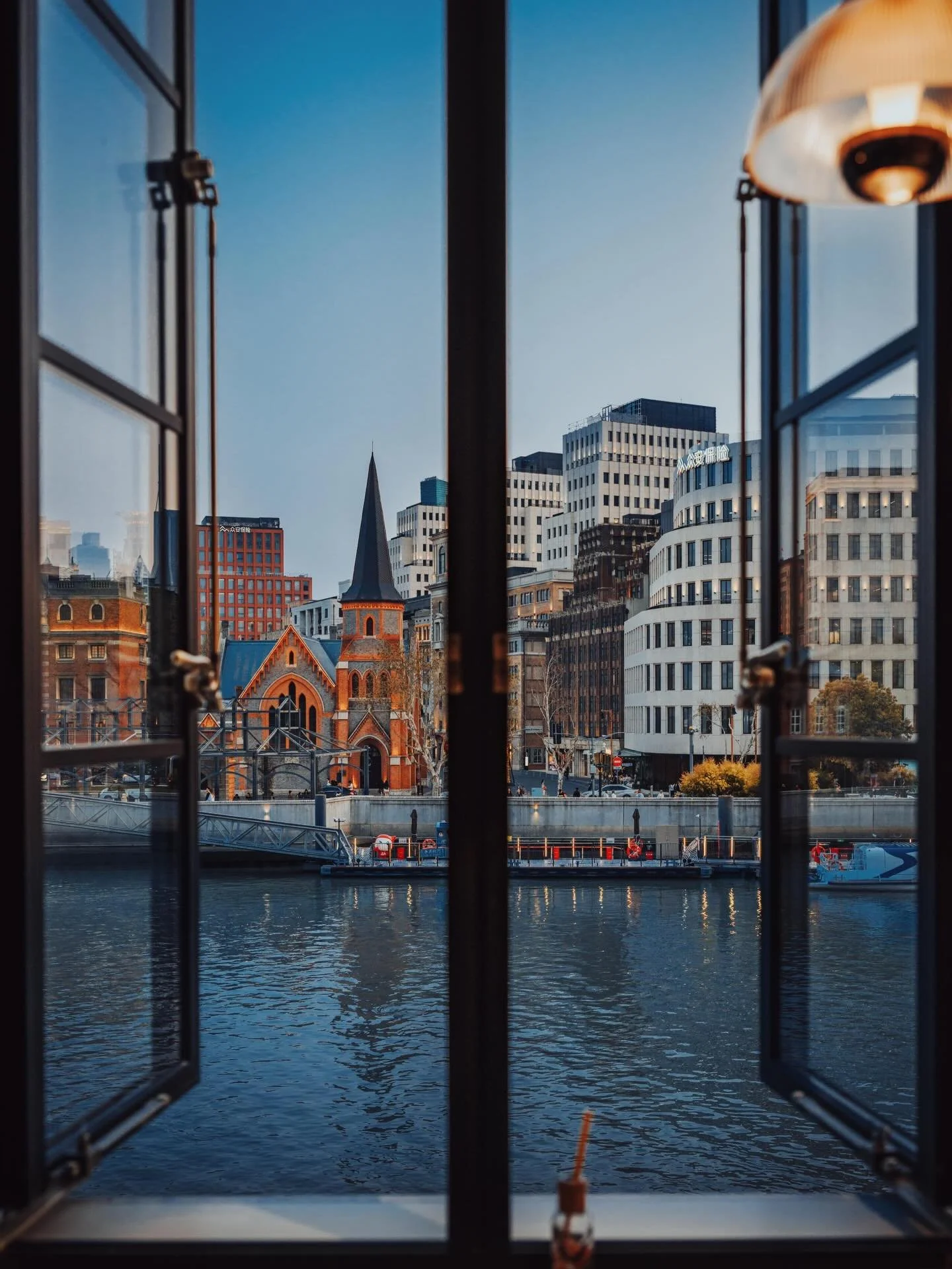 Along Suzhou Creek, Dayin Bookstore (大隐书局) takes the form of a docked ship. The building&rsquo;s curved white structure and elongated profile echo the silhouette of a cruise liner, turning the bookstore itself into an architectural object on the rive