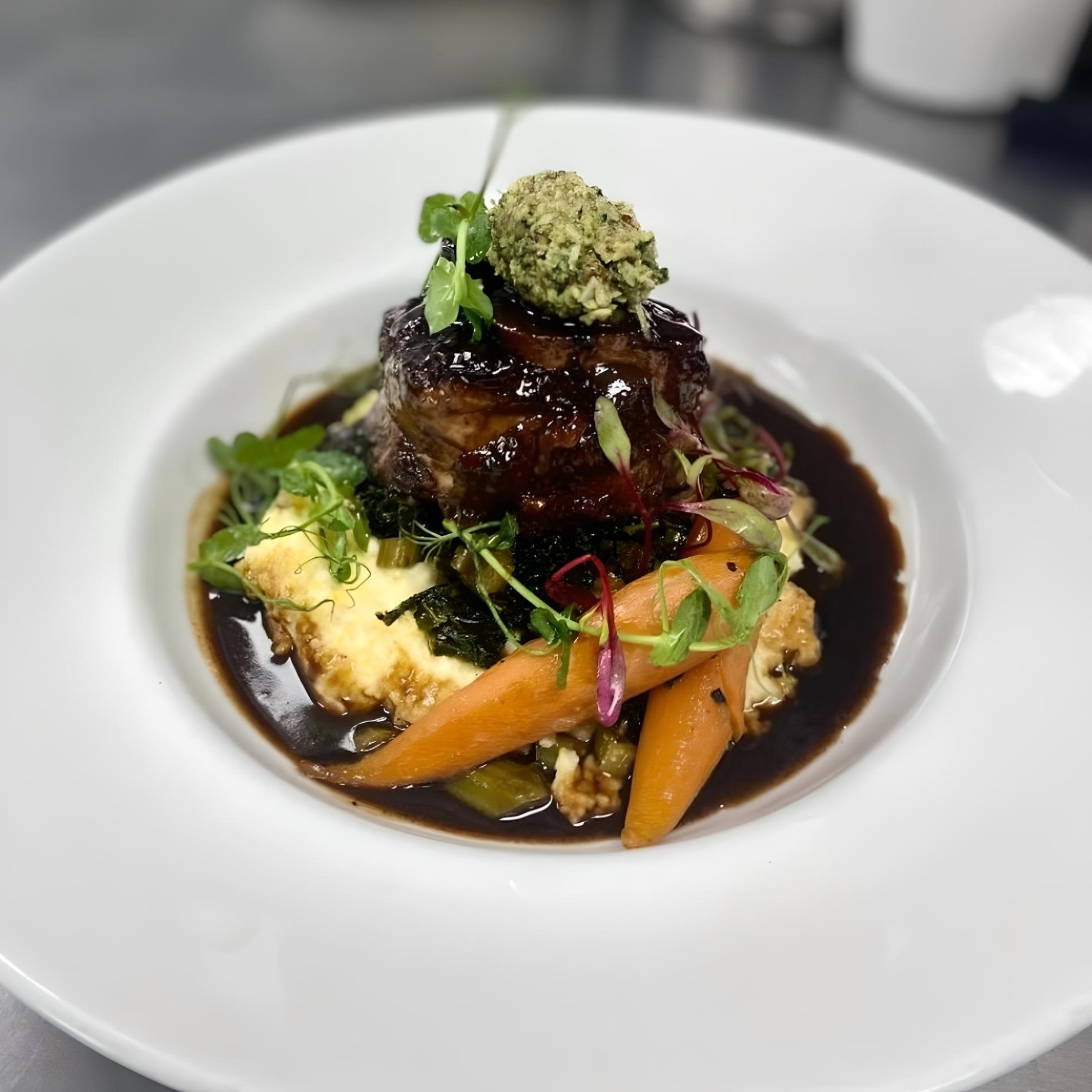 Pork Osso Bucco, Parmesan Pecorino Polenta, Souvide Herb Carrots, Veal Jus, topped with Basil Gremolata 