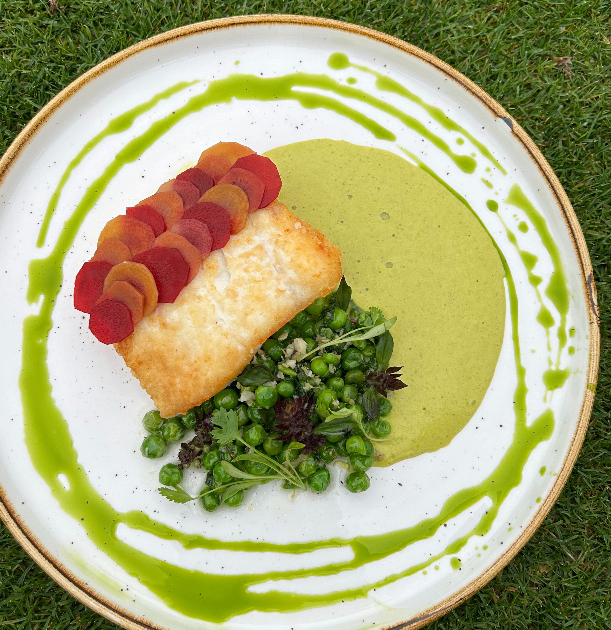 Seared Halibut, Tri Color Pickled Carrots, Pea Thai Curry Mousse, Sauteed Peas, Topped with Cilantro Oil and Thai Basil Flowers
