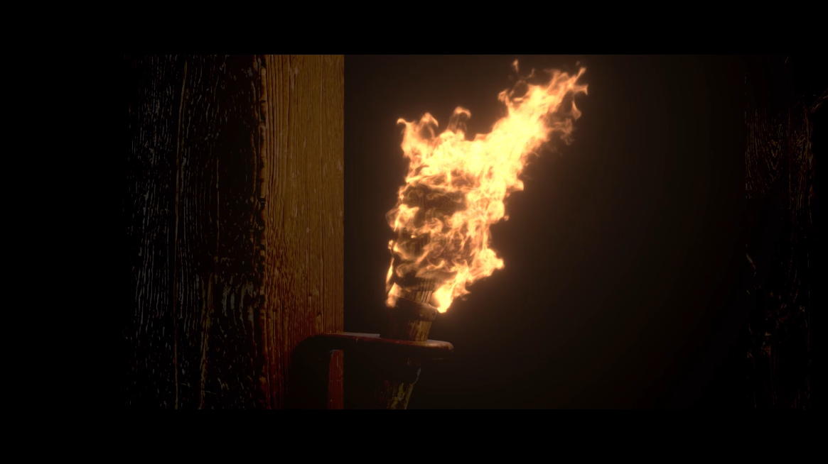 Torch on a wooden surface with flames coming out of it.