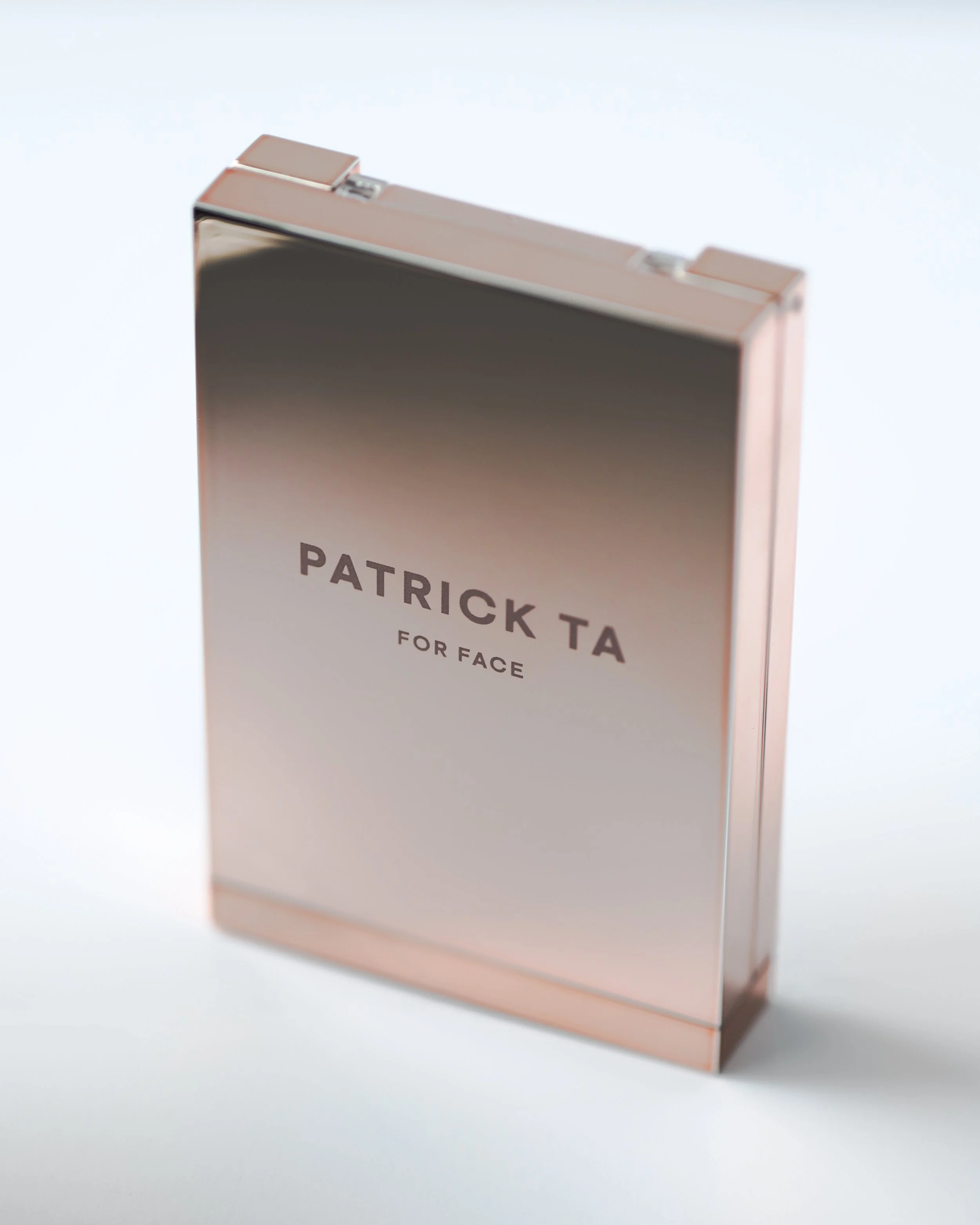 Rose gold compact case with the words 'Patrick Ta for Face' on the front.