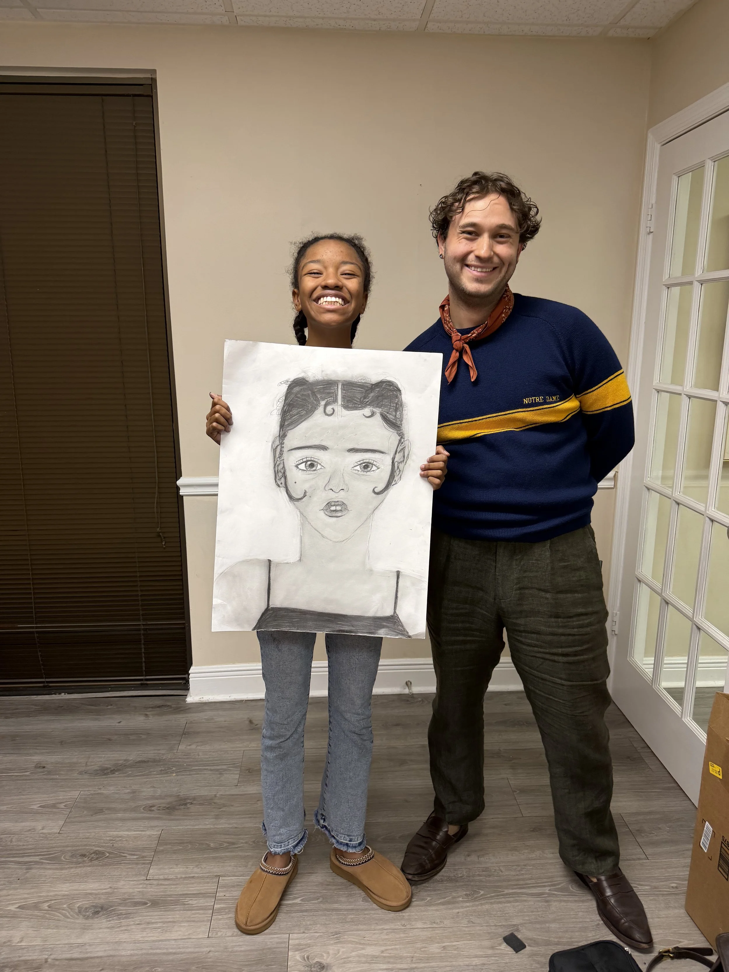 Art school applicant holding successful portfolio self portrait