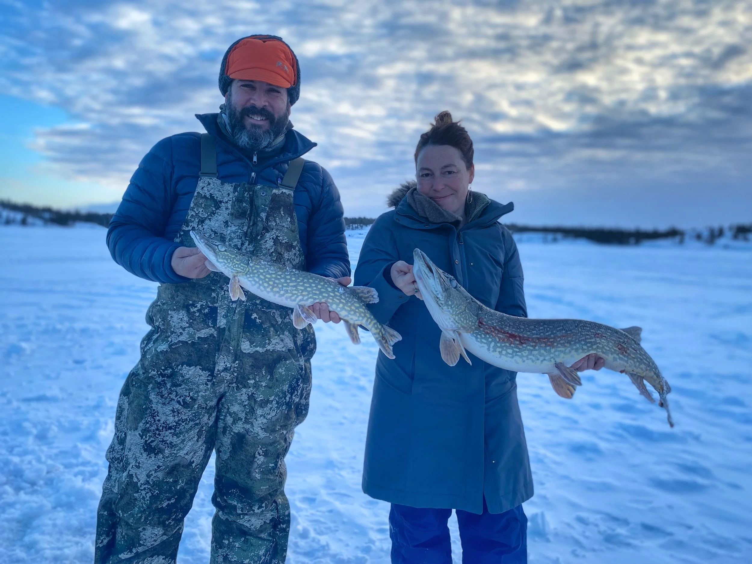 Annemarie catching the largest northern pike of the season at 38", Yellowknife, Northwest Territories, January 2024