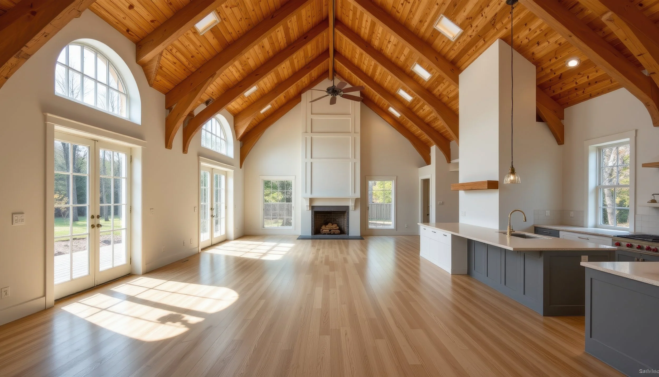 New construction custom home interior with vaulted wood ceiling and open floor plan