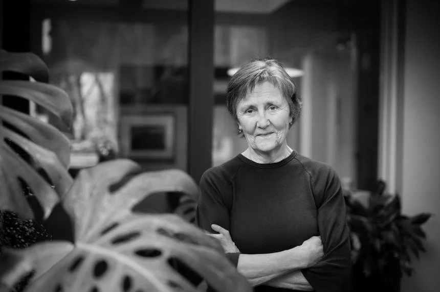 Black and white photo of a crossed-armed Helen Garner, credit to Darren James