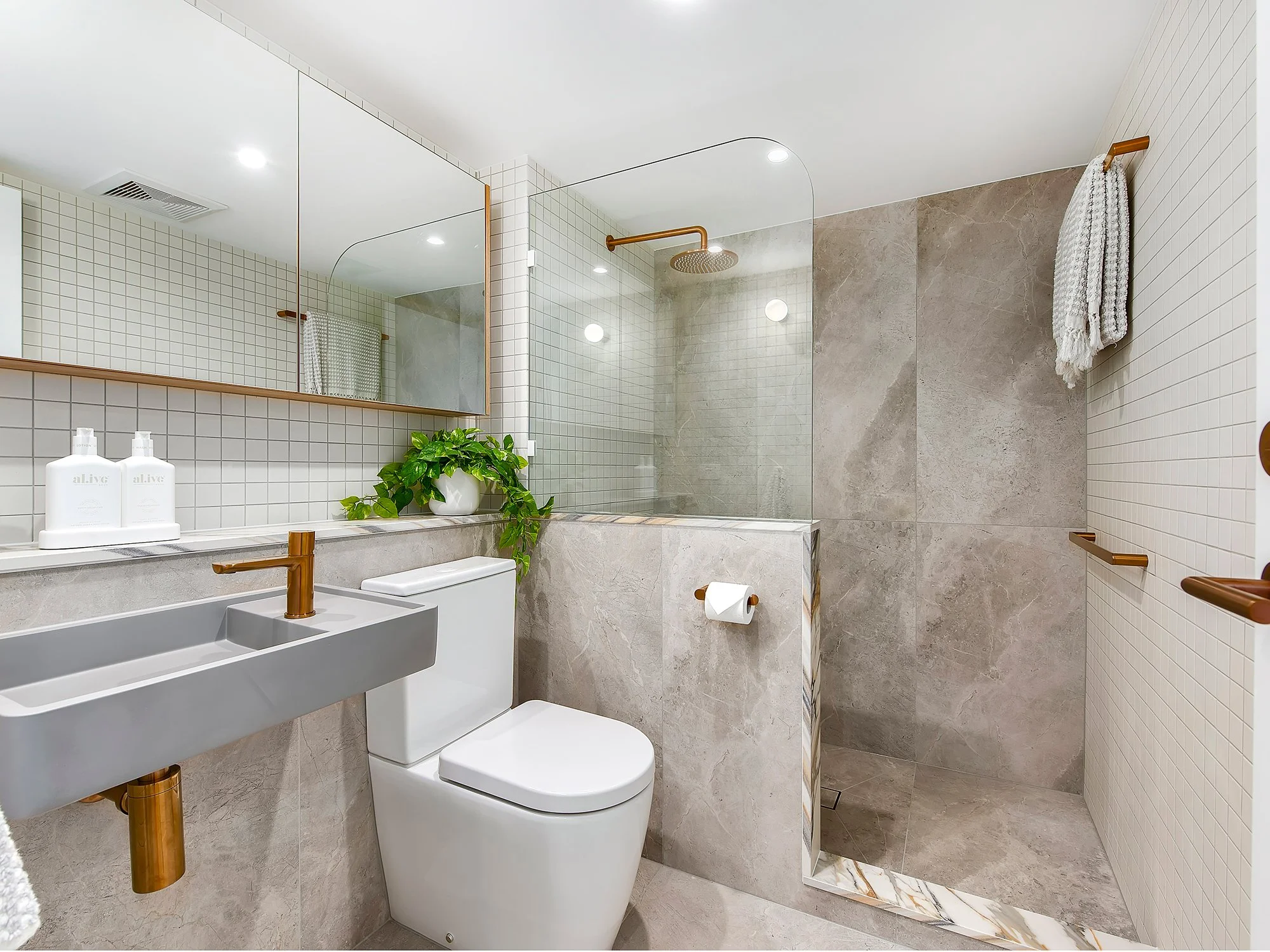 This bathroom feels calm, considered and quietly elevated. Natural tones set the foundation being warm, grounding and timeless. Oversized tiles keep the space feeling open while a white feature tiles adds just enough texture and contrast without over
