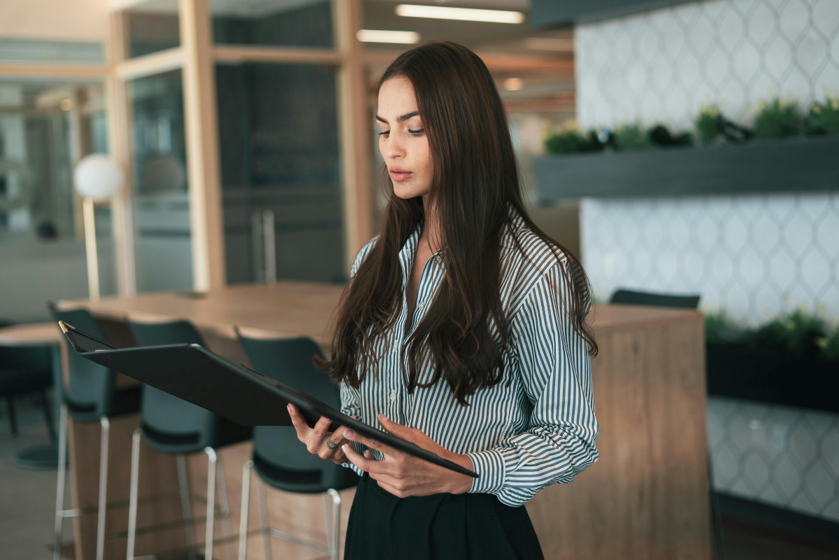 A woman in an office looking at a professional resume in Melbourne Australia on her laptop