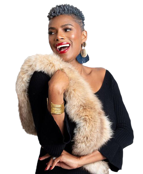 A woman with short gray hair, bright red lipstick, and large earrings wearing a black top and a beige fur stole, smiling and holding the fur with one hand.