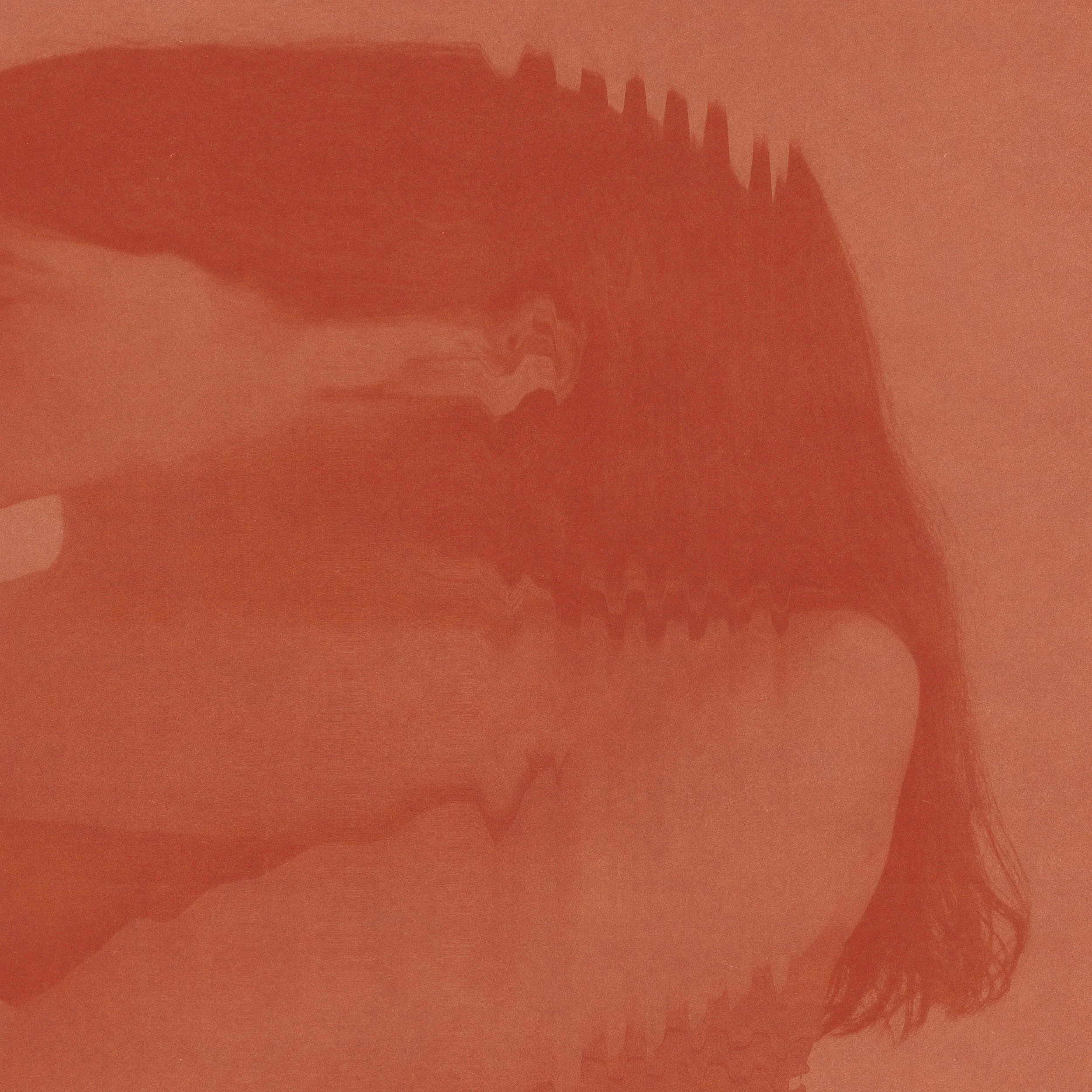 Close-up image of a person with curly hair resting their head on their hand.