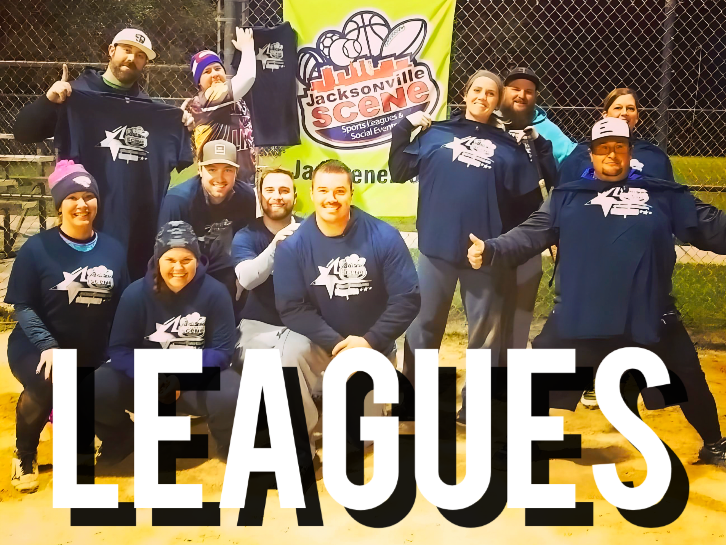 Group of people wearing Jacksonville Scene apparel, posing on a baseball field at night, celebrating their league victory.