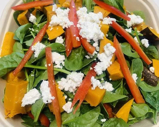 Mixed vegetable salad with spinach, feta cheese, sweet potato, and diced capsicum.
