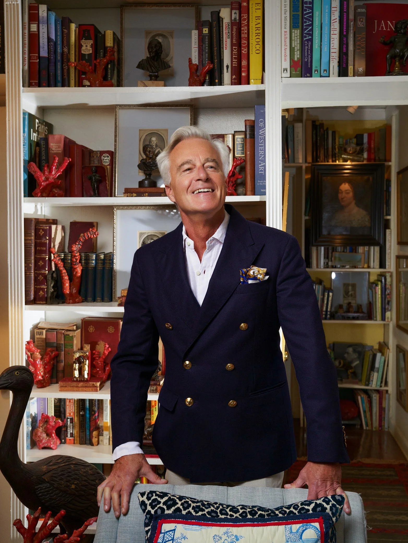 Le Basque co-founder, Ian Perris,  in a navy blazer standing beside a bookcase