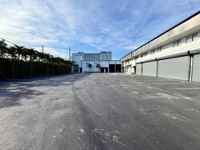 courtyard of venue showing roll doors and expansive parking lot