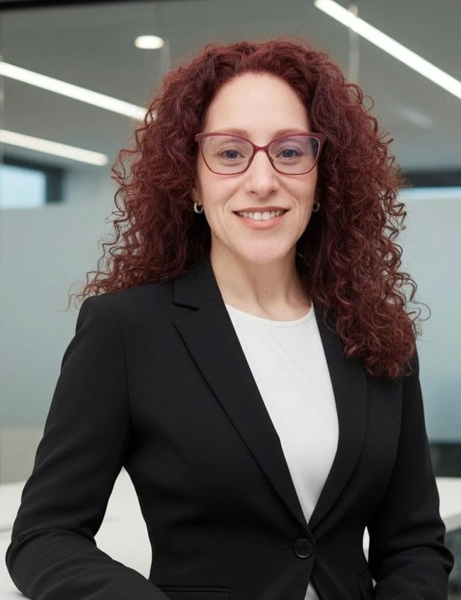 Deborah standing in a modern office setting.