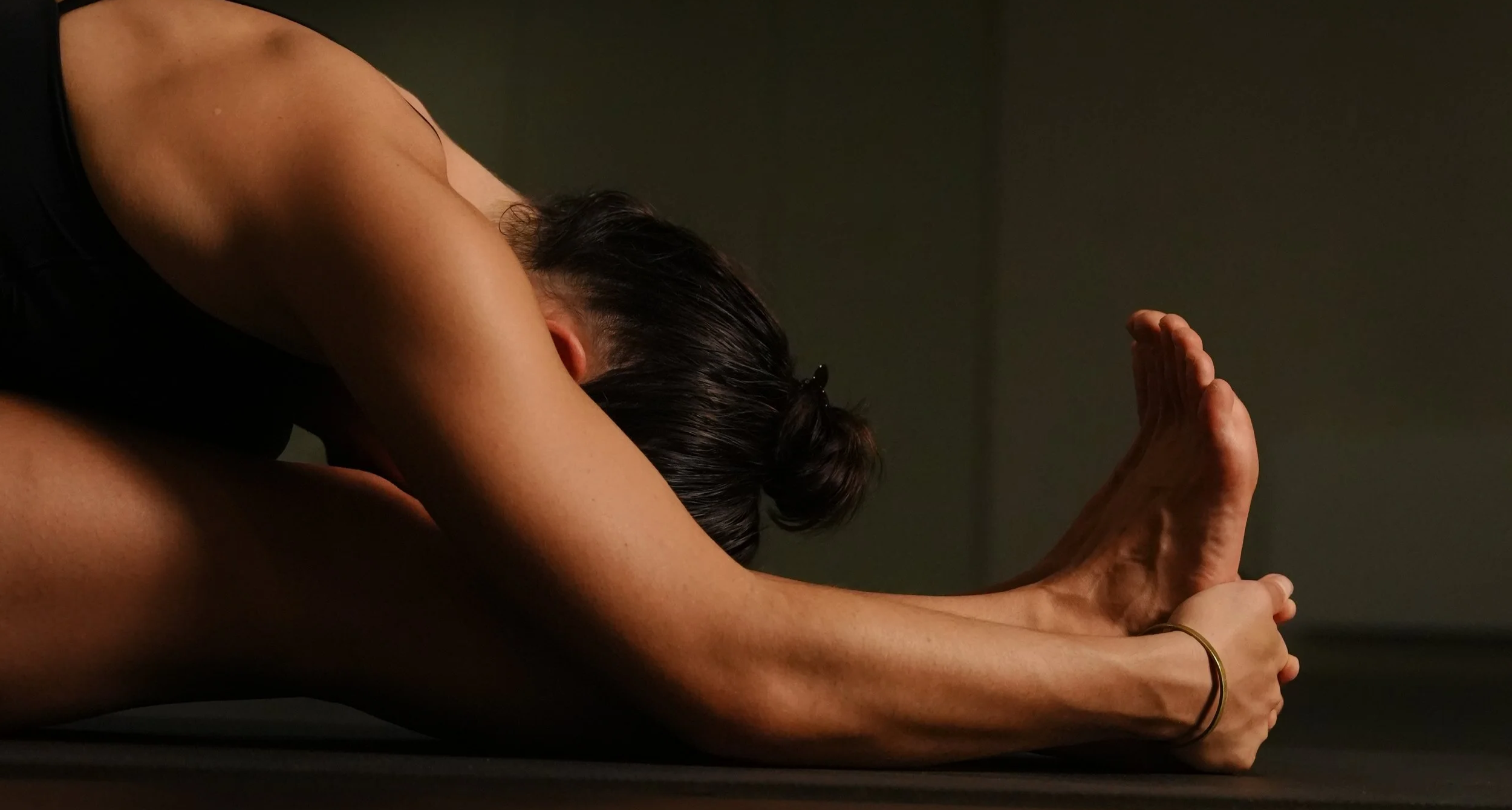 yoga in forward fold, paschimottanasana, for a calm yoga practice to reset the nervous system and create more energy