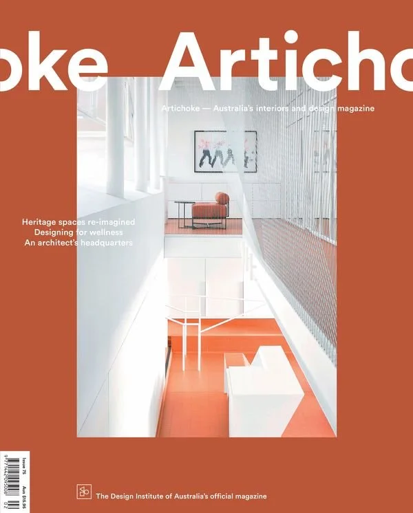 Cover of Artichoke magazine featuring a modern, minimalistic interior with white walls, orange flooring, and contemporary furniture, including a chair and framed artwork.