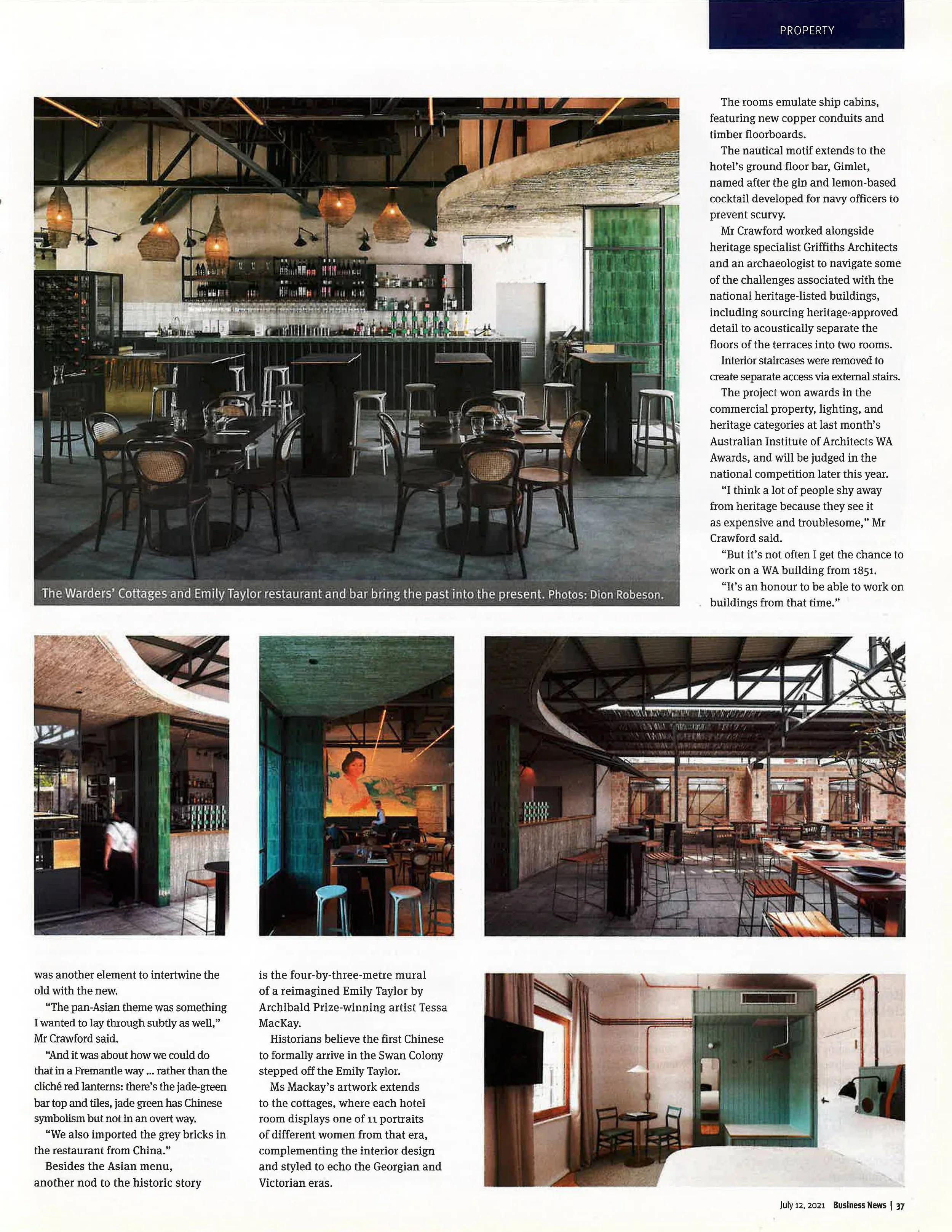 Interior of a modern restaurant or bar with high ceilings, exposed beams, pendant lighting, and a fully stocked bar area with chalkboard signs. The space features a mix of tables, chairs, and bar stools, with a combination of industrial and rustic design elements.