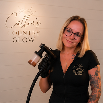 Woman with blonde hair and glasses holding a spray tan machine, standing in front of a sign that reads "Callie's Country Glow".