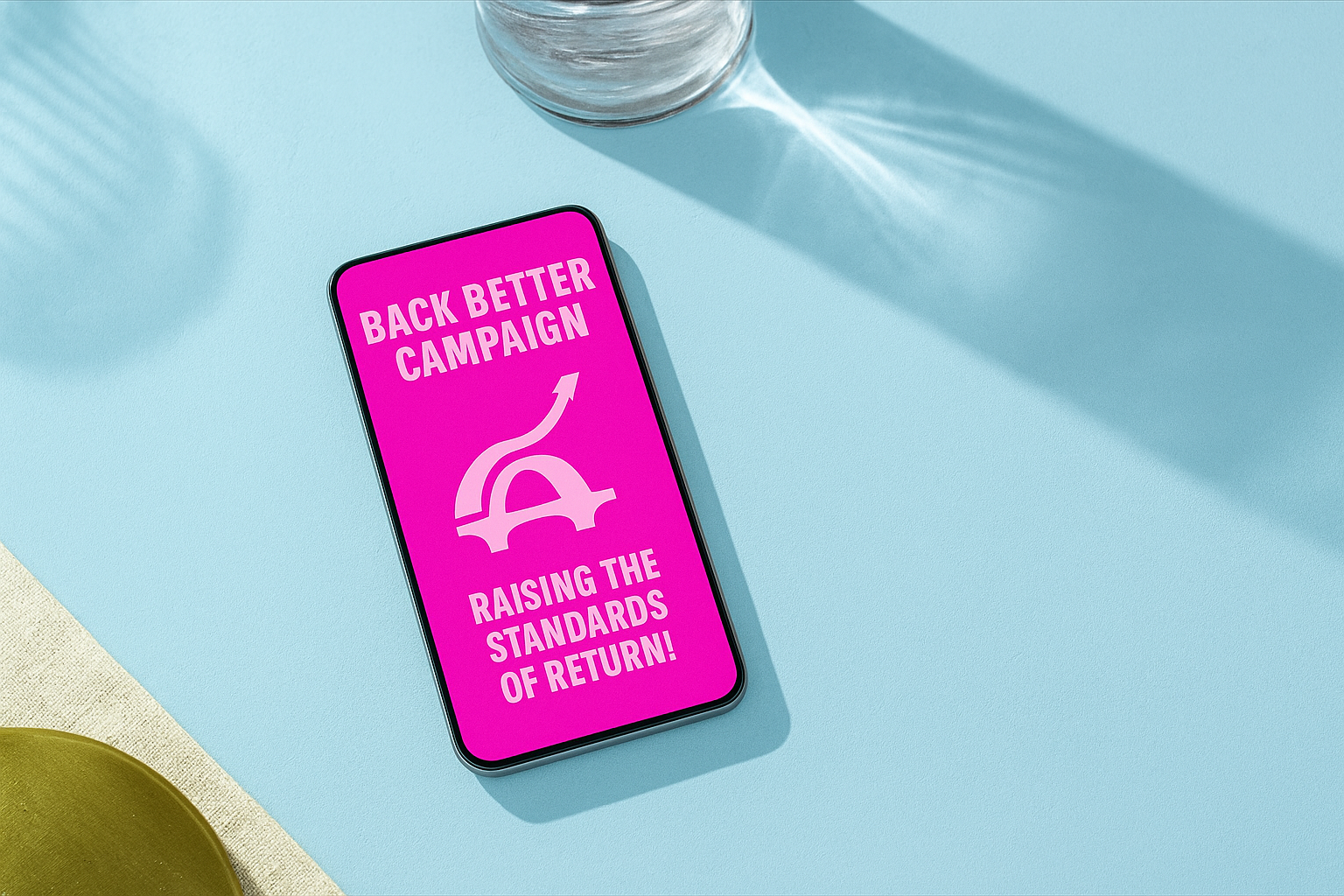 A smartphone displaying a pink screen with text about a campaign, placed on a light blue surface with a glass and a yellow cloth nearby.