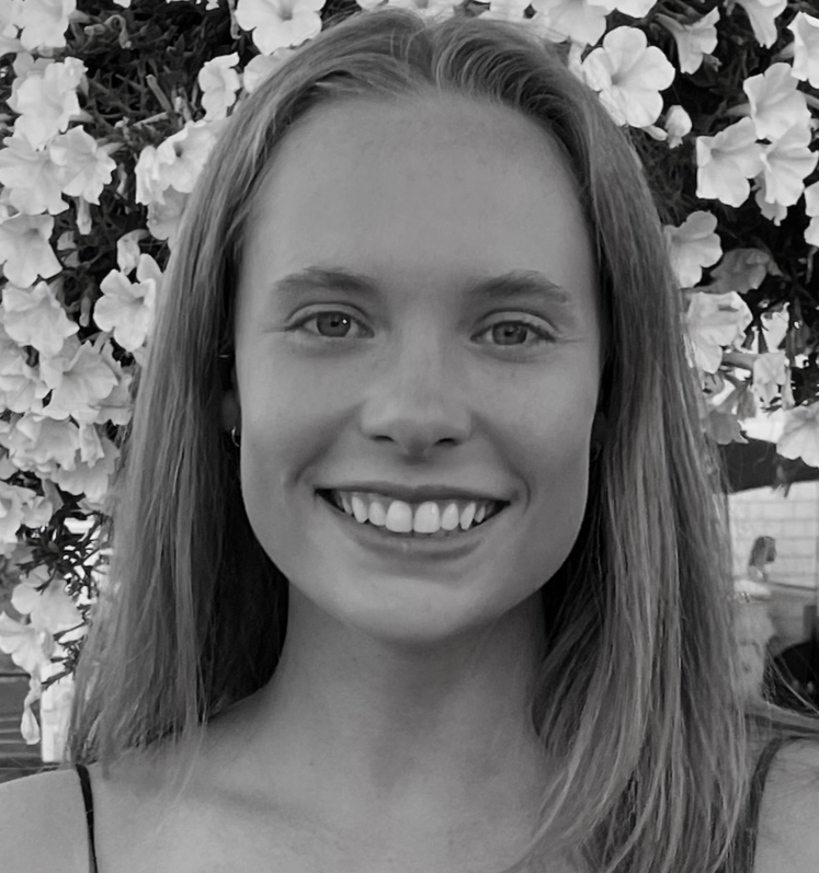 Chef and owner of Scottie's, Lily Scott, is pictured in front of a background of flowers.