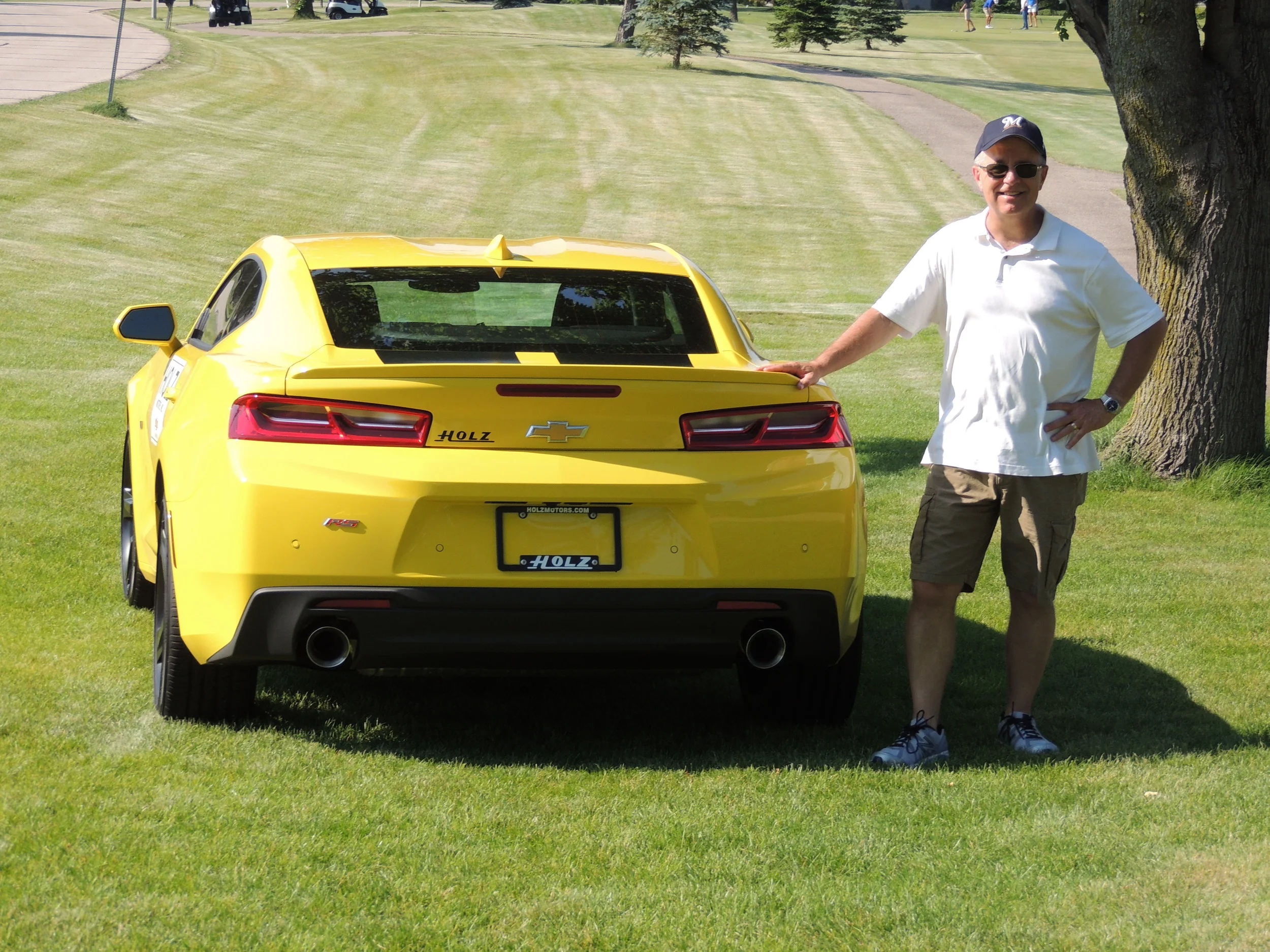 Bob W with Hole in one car.JPG