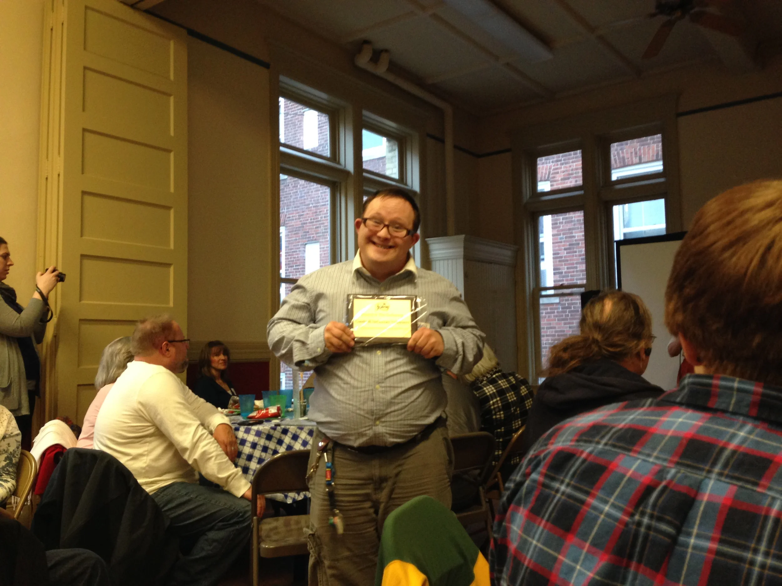 Matthew, breakfast volunteer, excitedly accepts the Goodwill Volunteers’ Friend of The Gathering Award