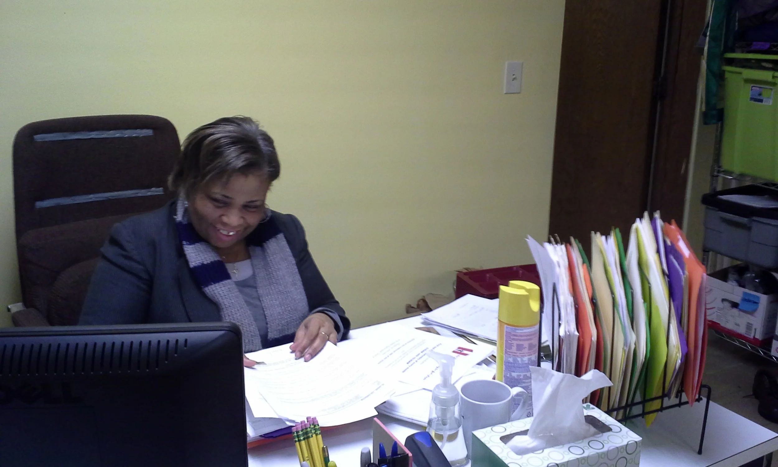 Angela sorts through sign-in sheets, community service paperwork and more after breakfast