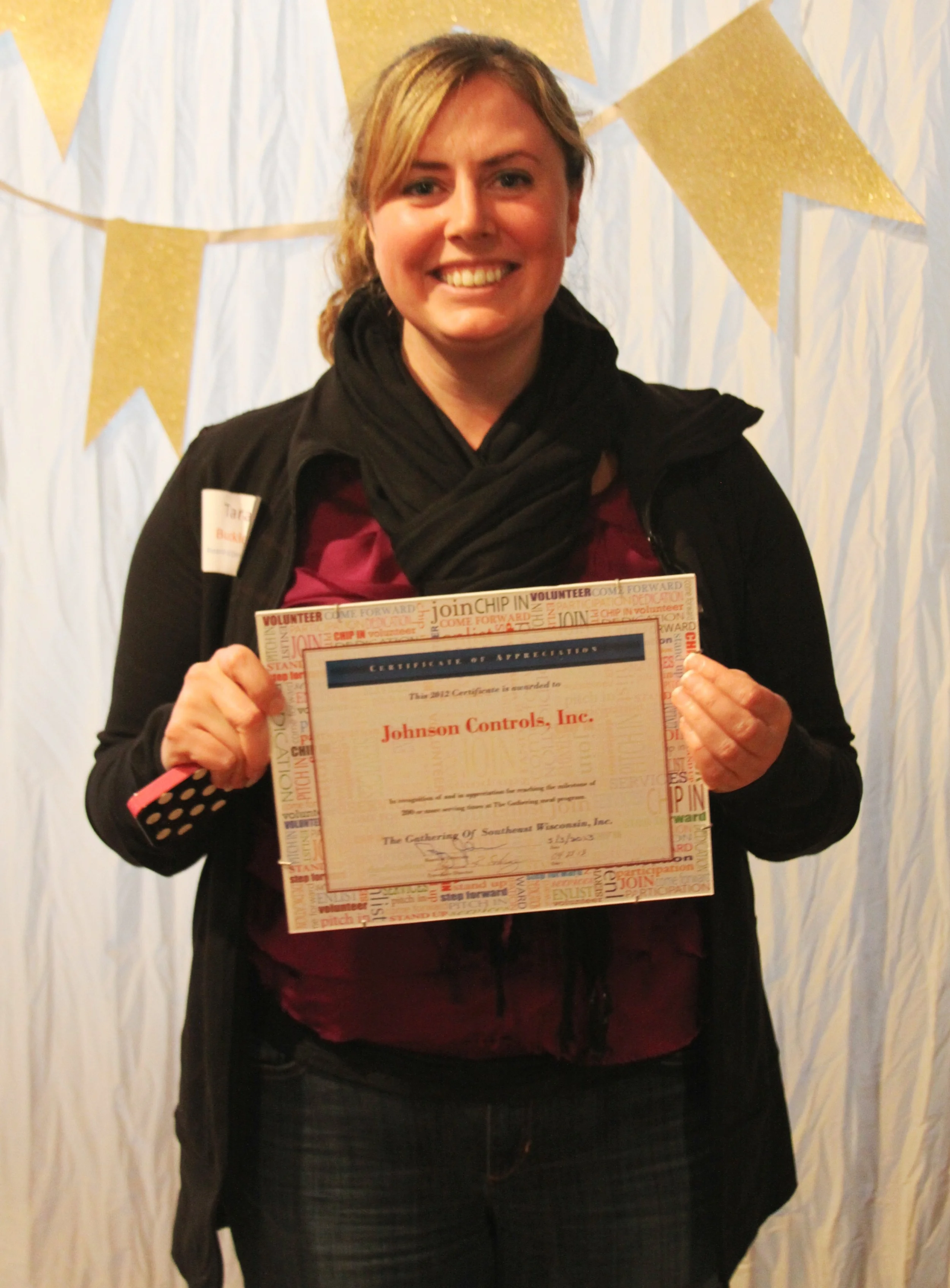 Board Member and Johnson Controls employee Tara&nbsp;accepts the award for JCI's 250+ times of service with the Gathering in 2012