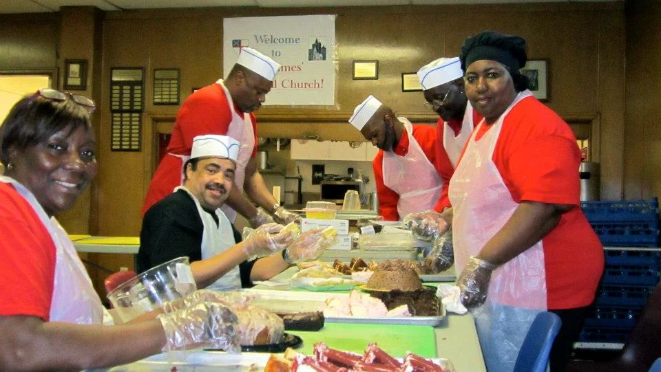 Volunteers preparing dessert tray at St. James
