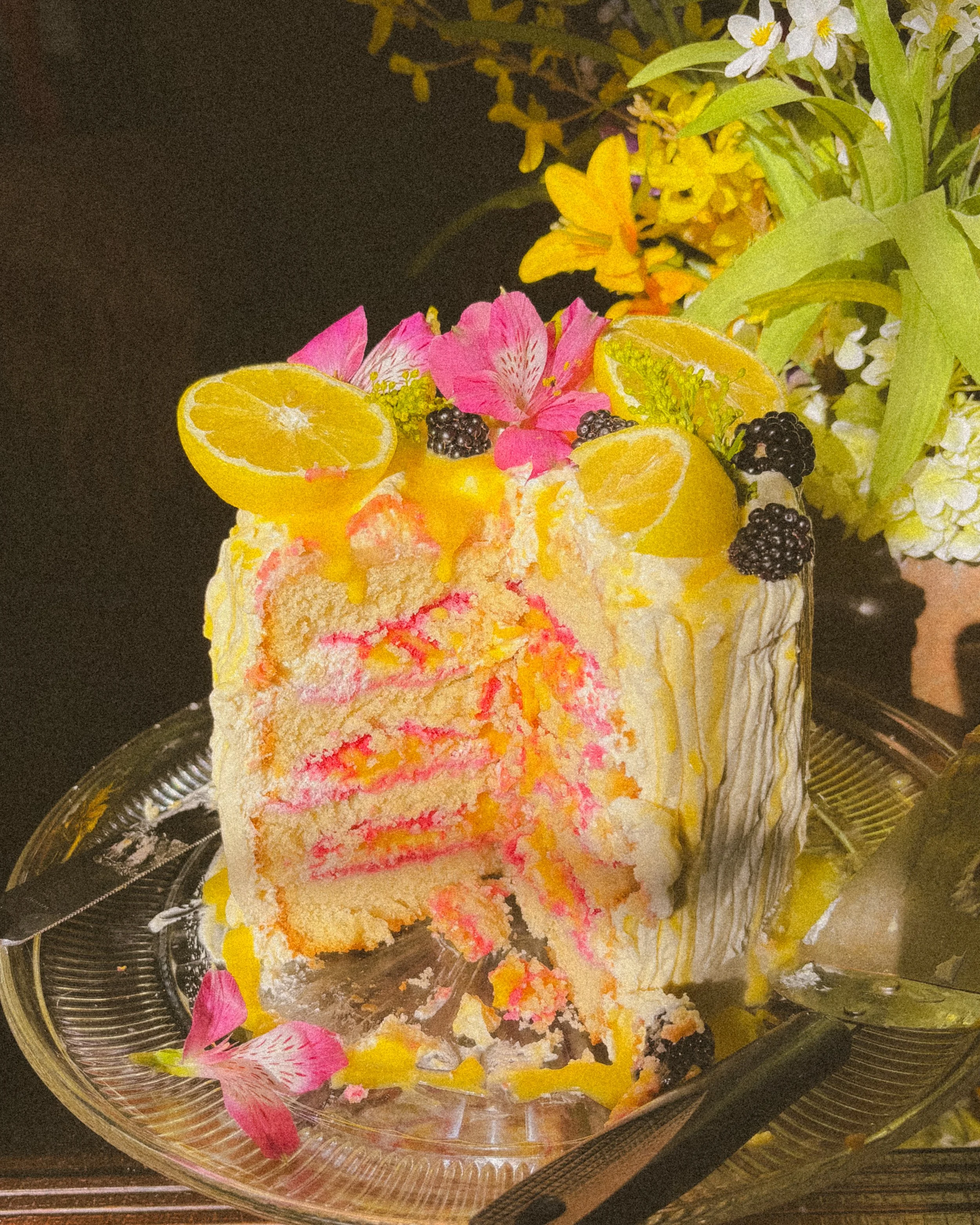 Picture of lemon cake with fruit and flowers on top