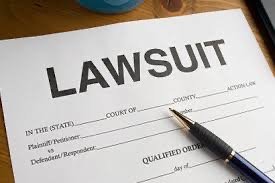 Lawsuit form with fields for court details, claimant information, and a pen placed on top.