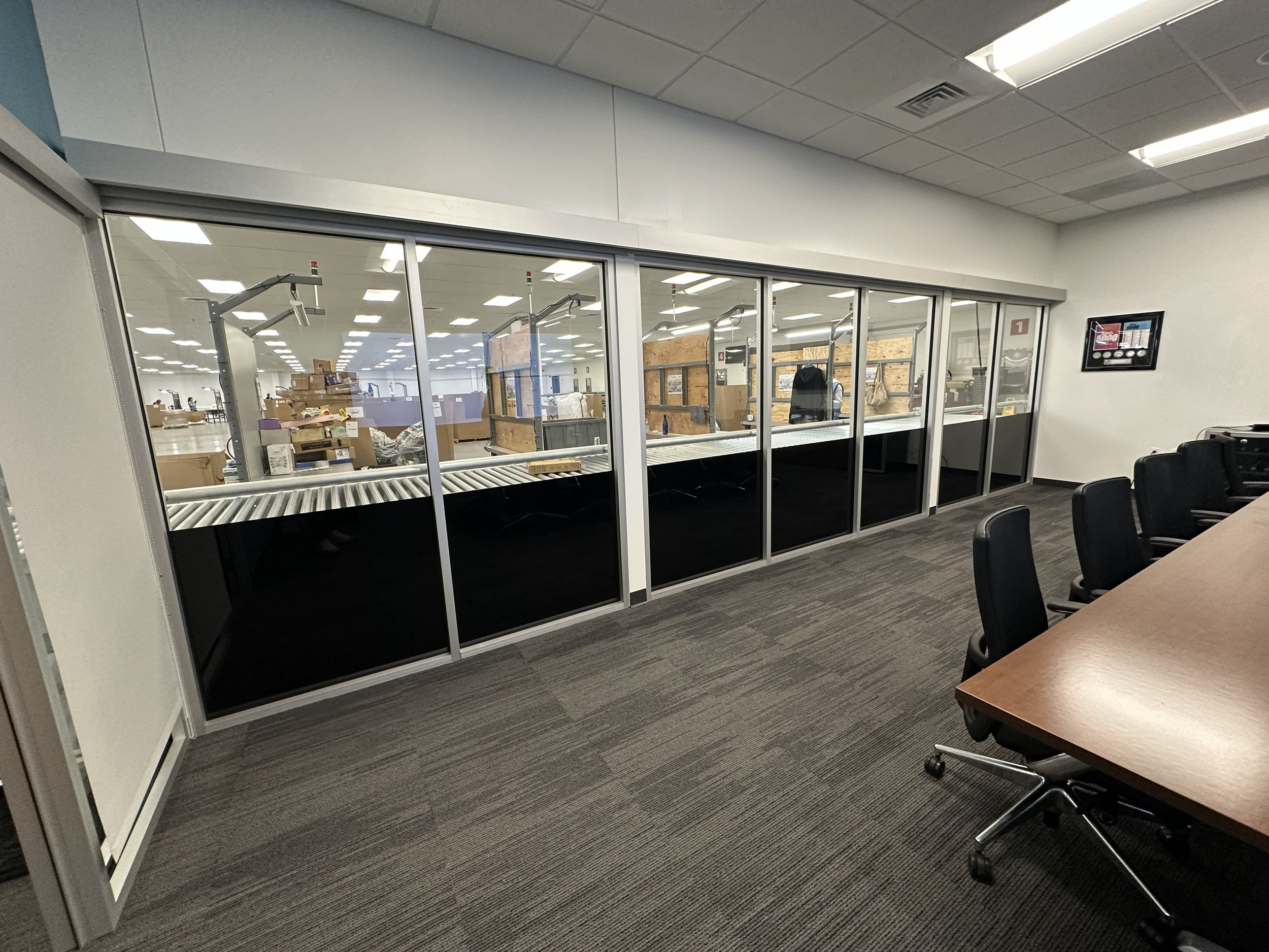 A Conference room with windows that are tinted with Blackout window Film  