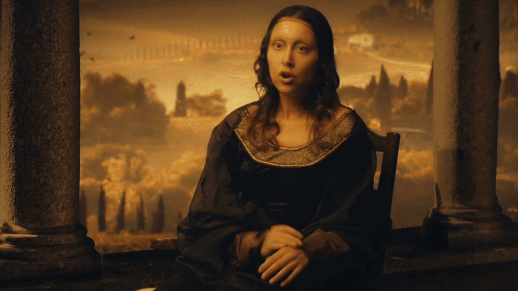 Woman with long dark hair and fair skin wearing a black dress with a gold collar, seated between stone columns with a painted landscape background.