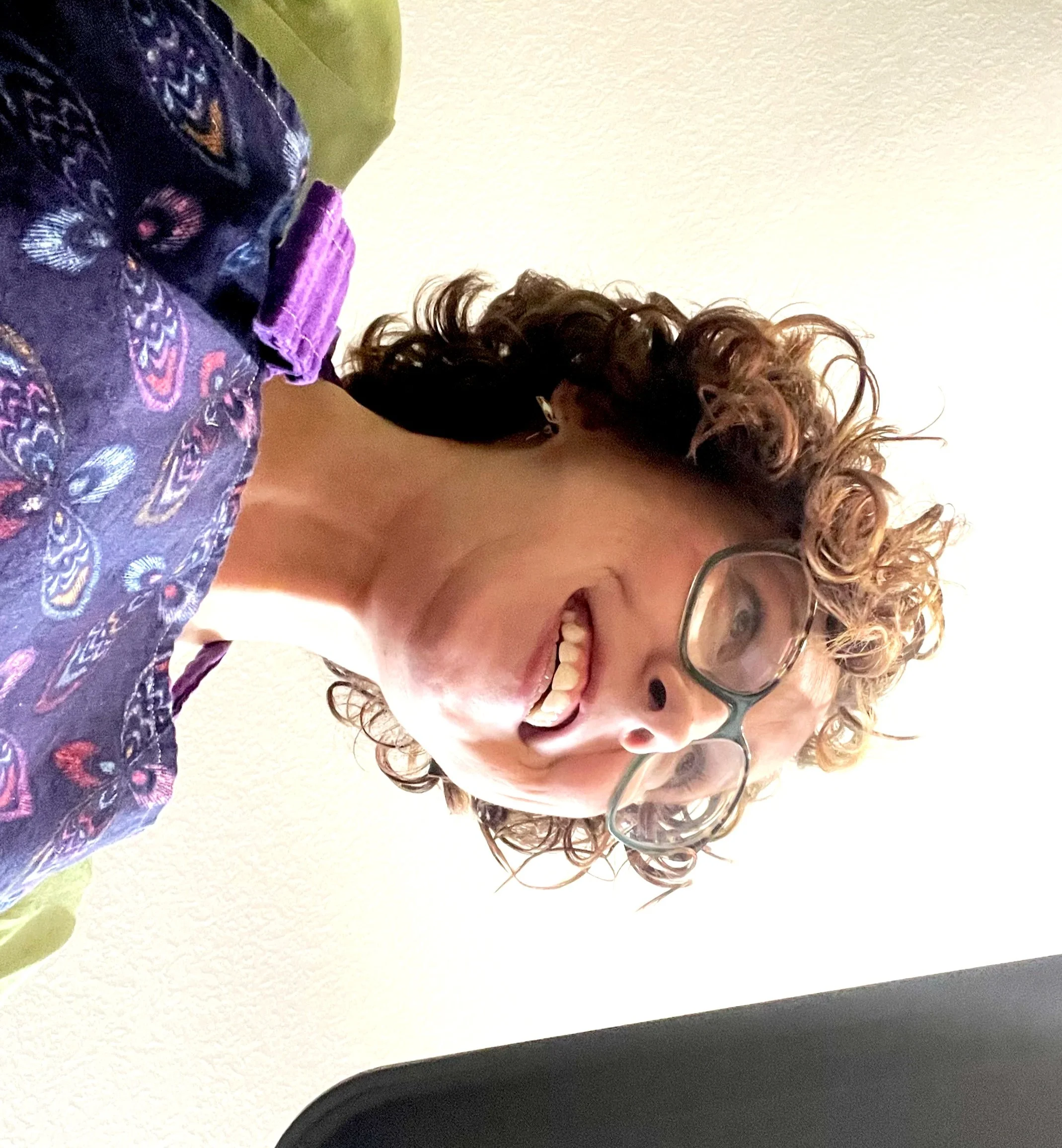 A photo captured from below by one of her children, wearing a purple apron, and holding a baking tray.