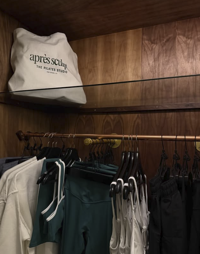 an image of The Pilates Studio's merchandise, including leggings, tank tops, crewnecks, and more