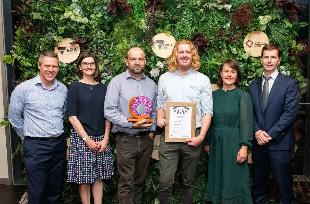 Paul smiles with Cassinia team holding award for Rokewood, winning Sustainability Award