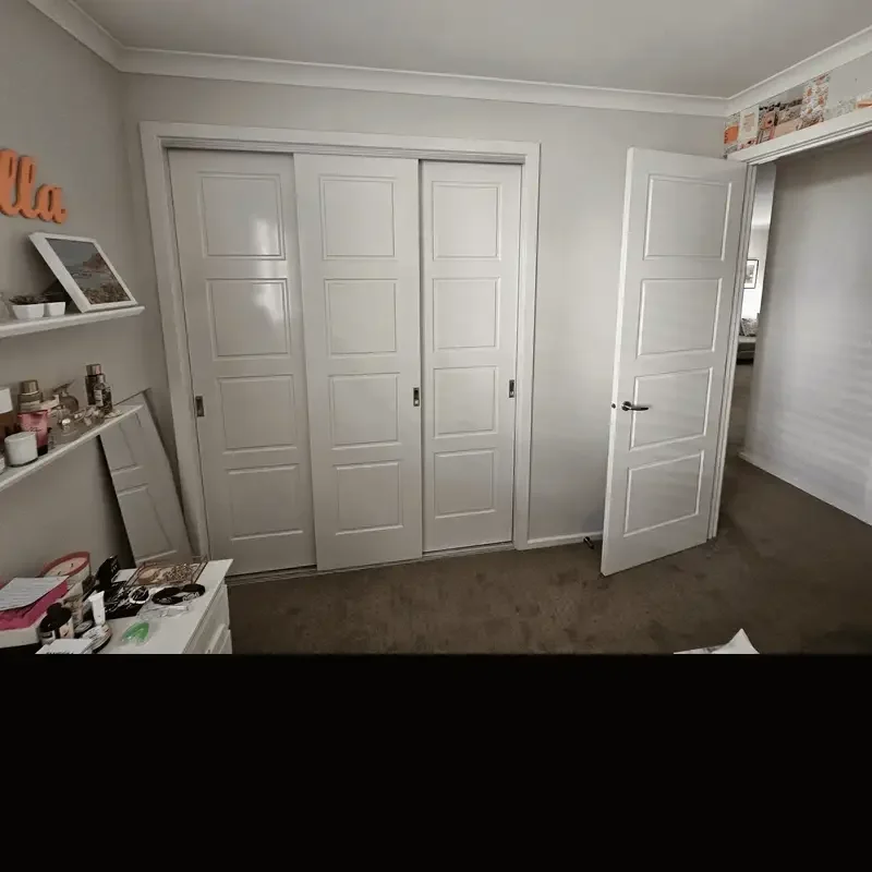 Walk-in wardrobe renovation in Balwyn North, Melbourne, showing the room before work and the fitted sliding wardrobe doors and completed carpentry after renovation.