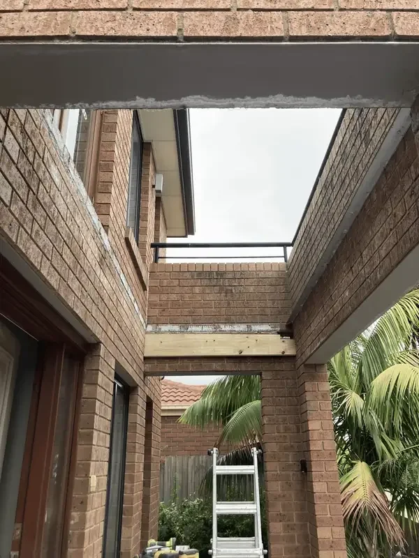 Subfloor waterproofing and tiling preparation in Berwick, Melbourne, showing the opened floor area before work and the prepared surface through the renovation process.
