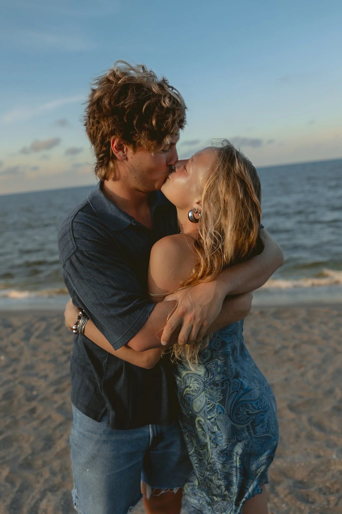 young man and woman kissing on the beach