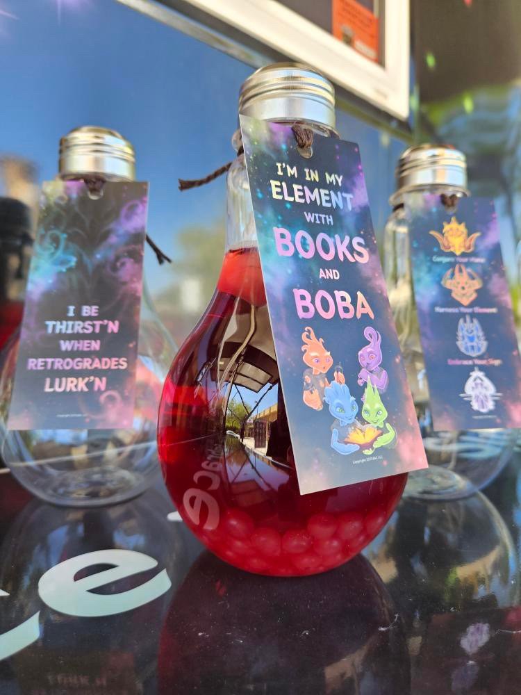 Souvenir potion bottle filled with tea and boba. Illustrative bookmark attached to bottle.