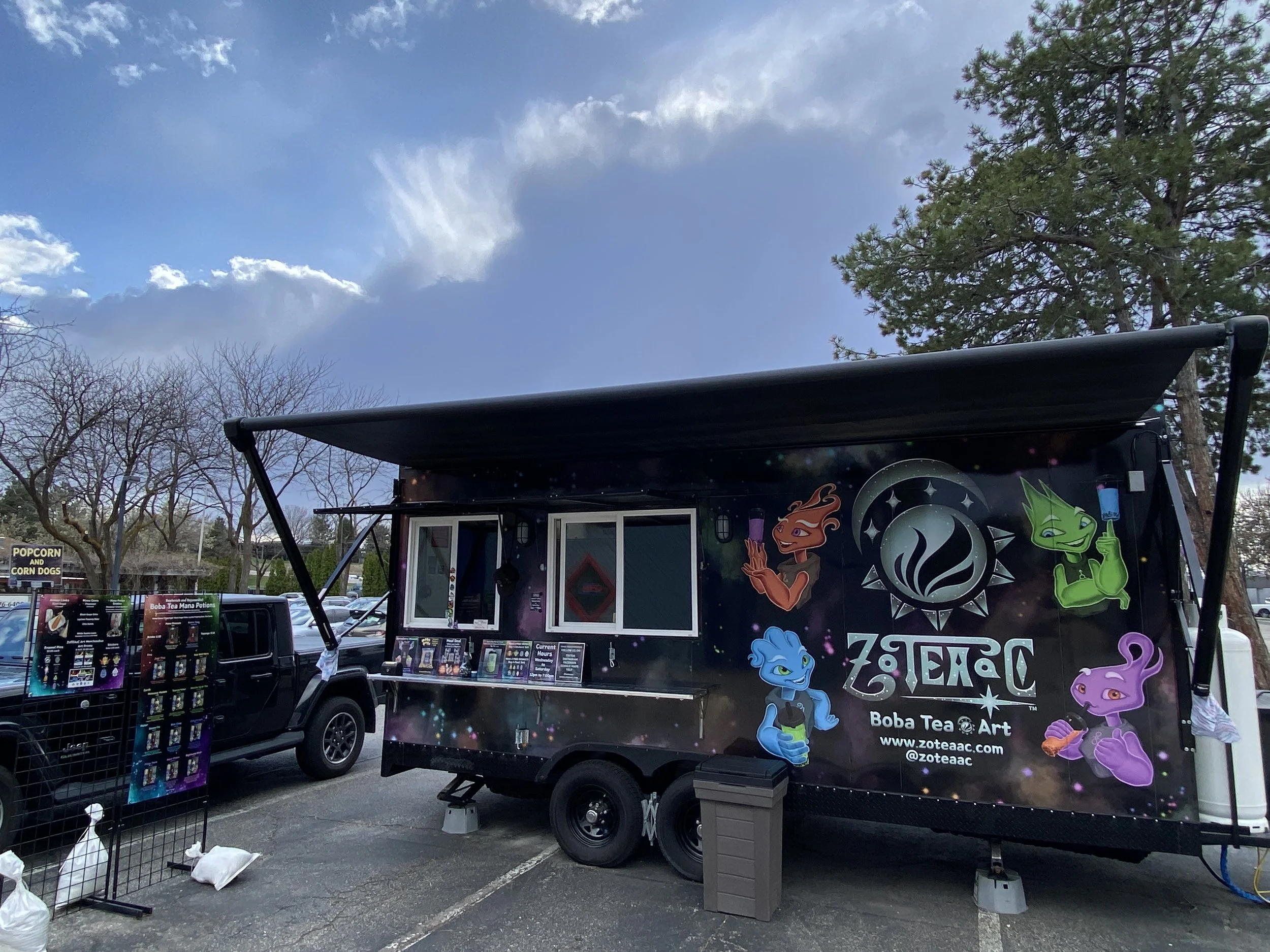 ZOTEAAC trailer window side with cloud scenery.