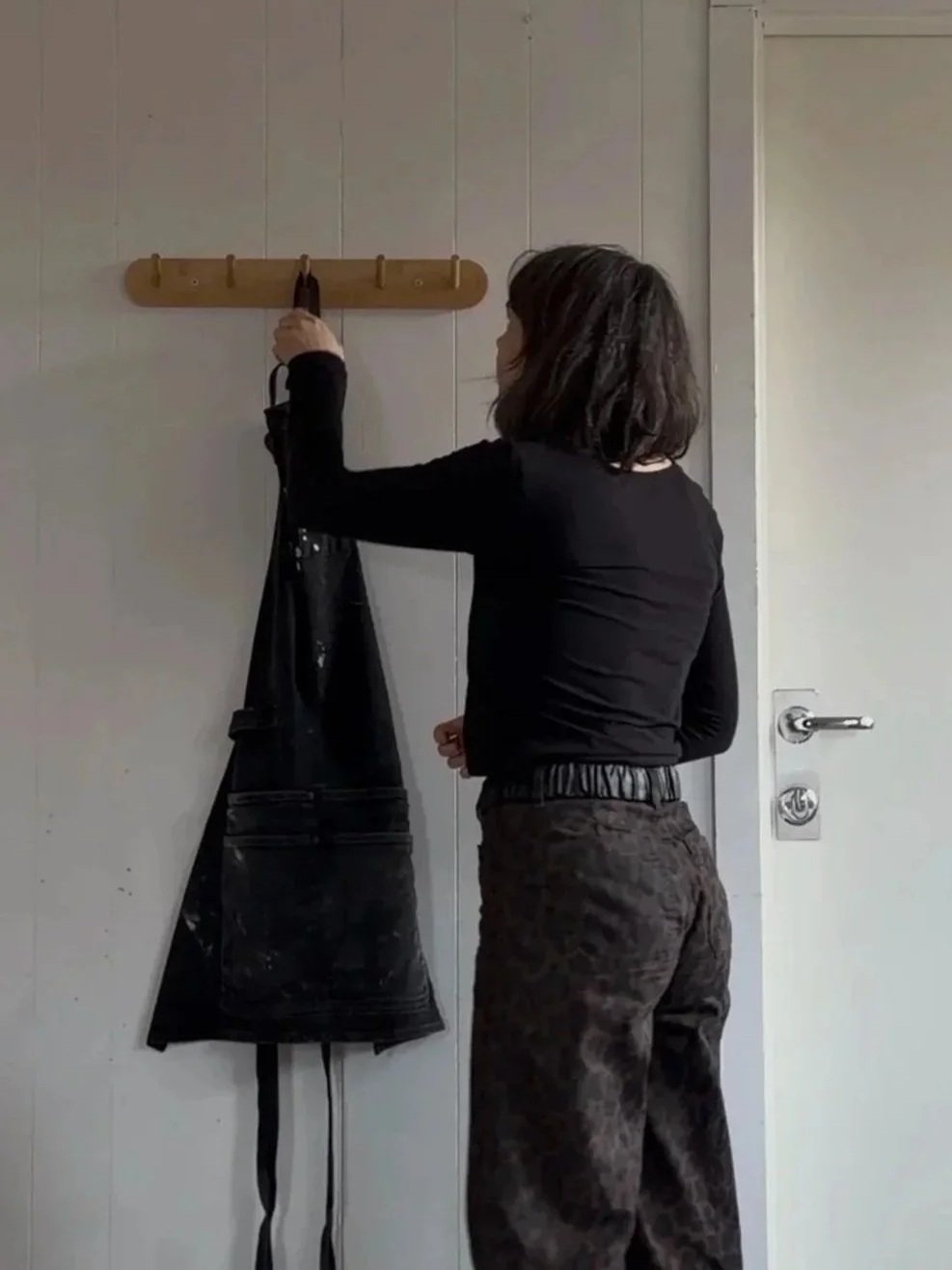 Potter taking her apron for work