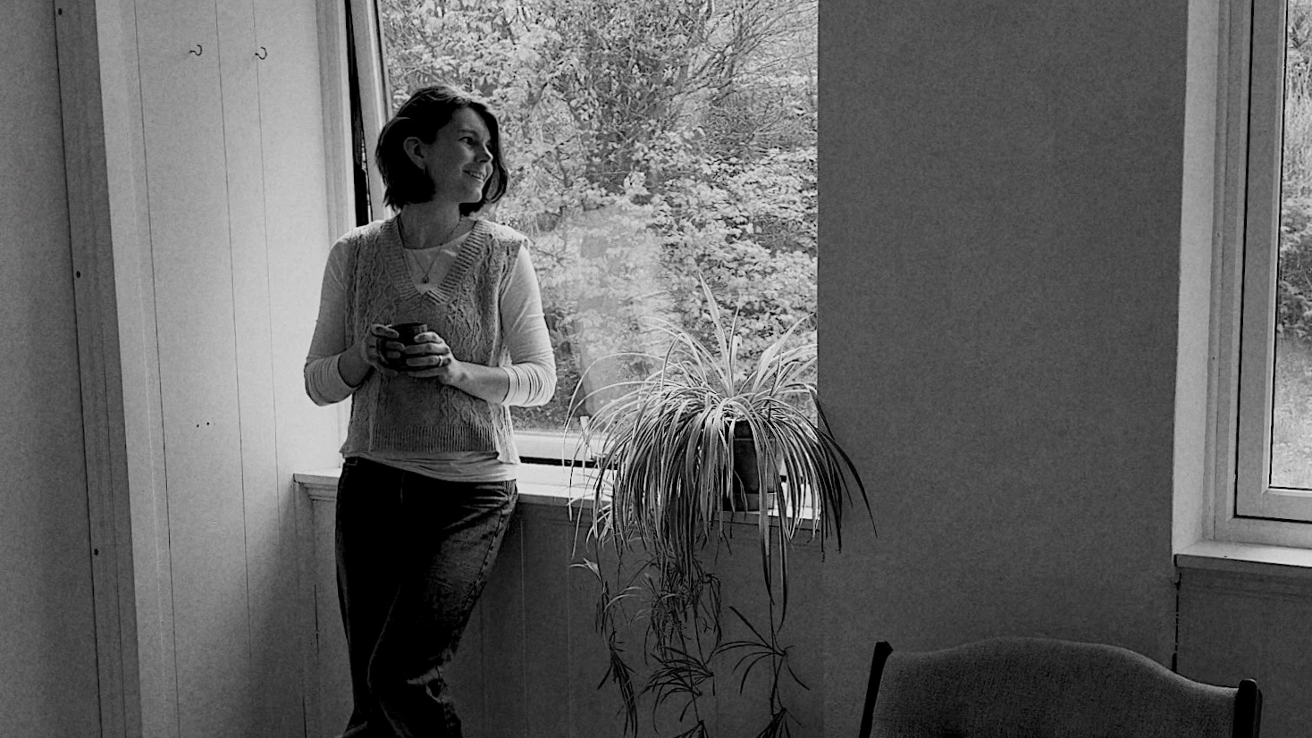 Self portrait of potter in the studio holding a hand made cup