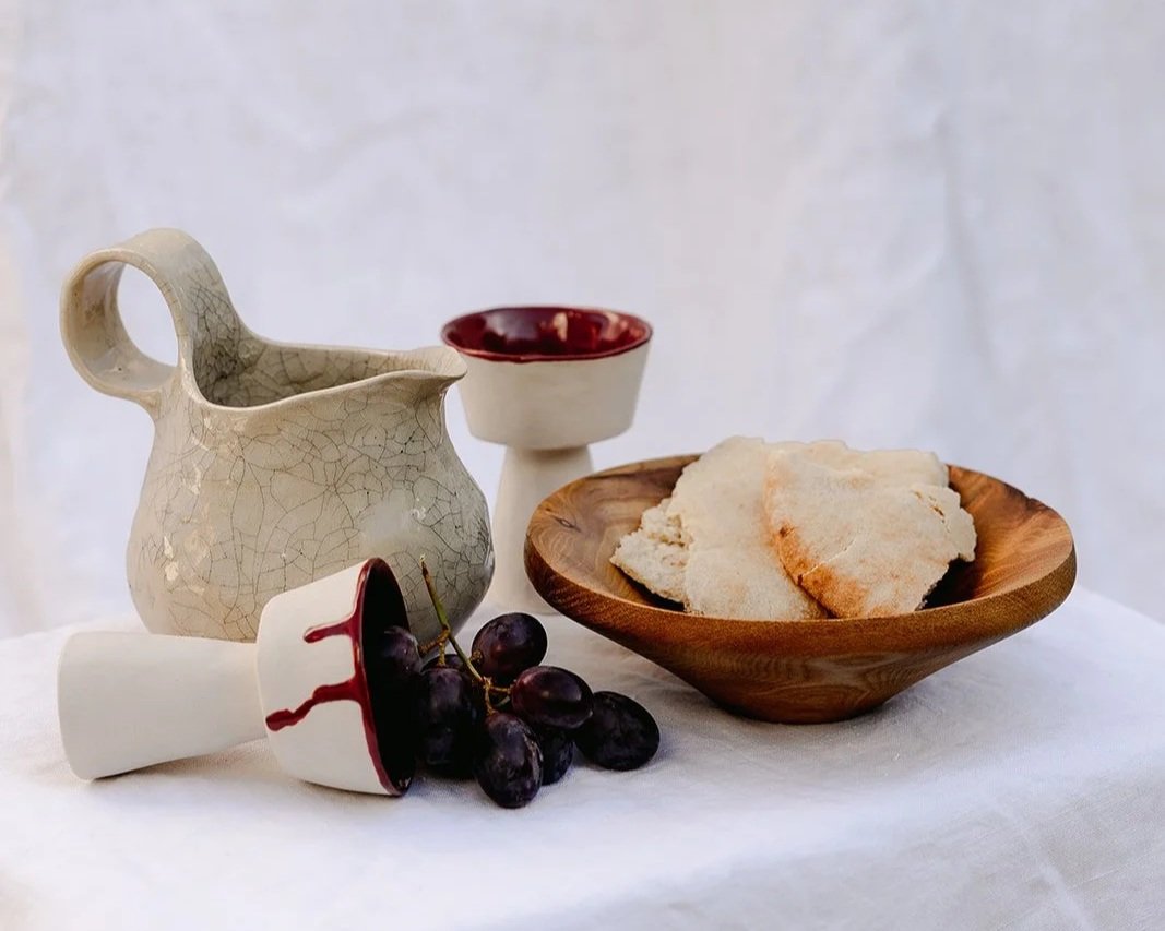 The breaking bread set with a handmade wine jug, two cups and a wooden bowl
