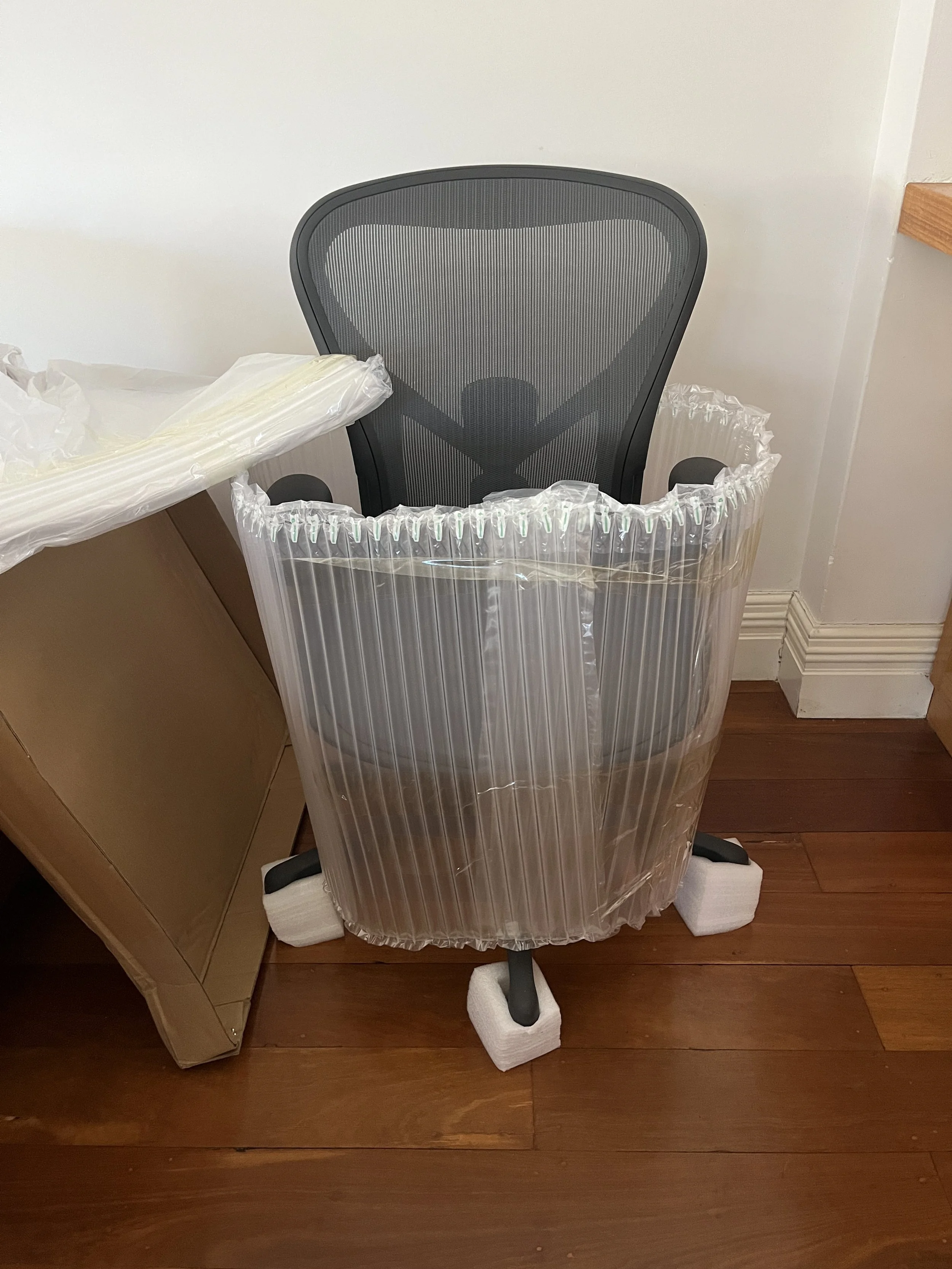 Herman Miller ergonomic office chair wrapped in brand new packaging