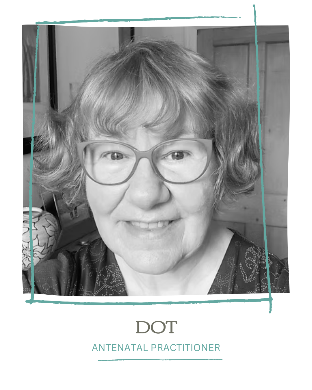 A black-and-white portrait of a smiling woman wearing glasses, with wavy short hair, in a casual indoor setting.