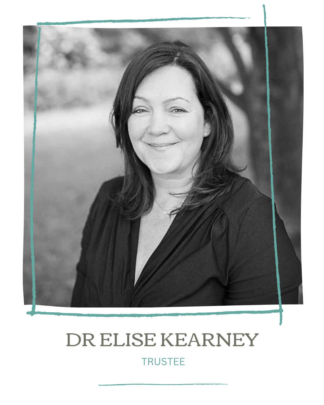 Black and white professional headshot of Dr. Elise Kearney, a trustee, smiling outdoors with trees in the background.